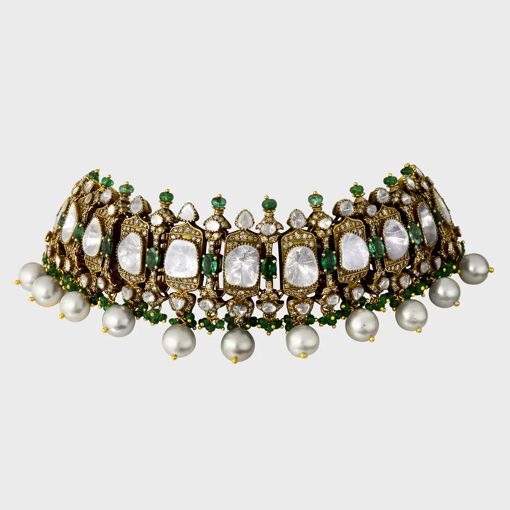 Exquisite flexible big Polki choker and earring set in fusion style, adorned with dazzling diamond rounds and emeralds. Elegantly strung with South Sea pearls and emerald beads - KMNE3565